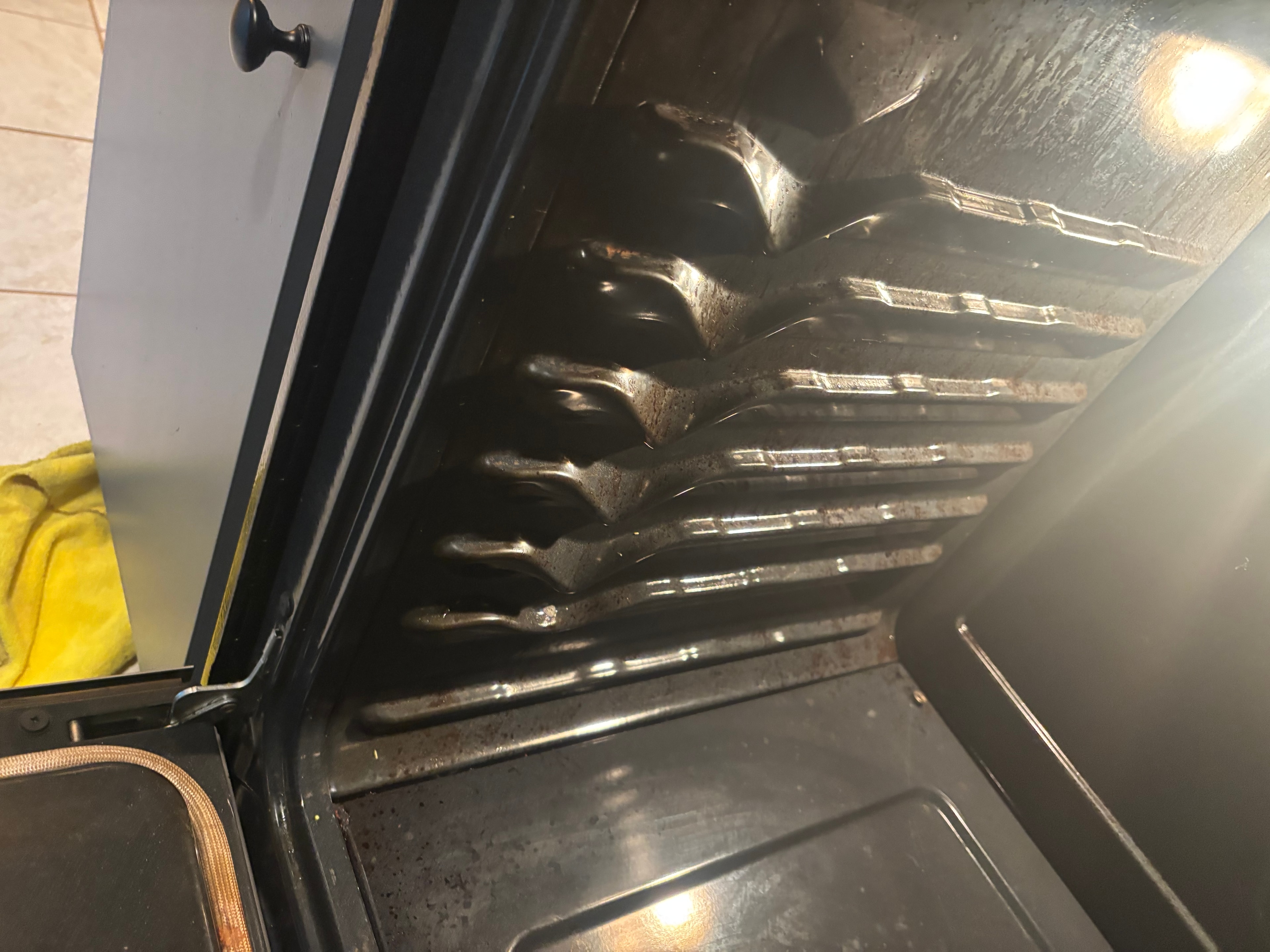 Oven interior grimy with dirty door glass before cleaning